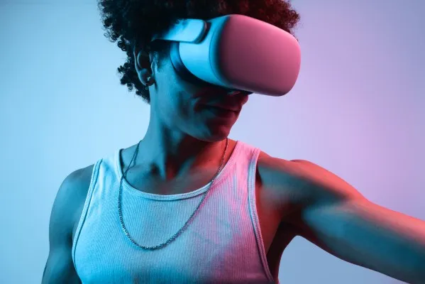 A man wearing VR glasses exploring an immersive experience, showcasing the possibilities of virtual reality development.