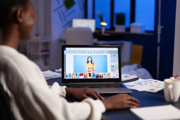 Woman refining images as part of digital marketing services for an online brand strategy.