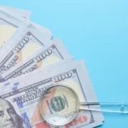 Nearshore benefits visualized through cost reduction and increased profits represented by a pile of dollars.