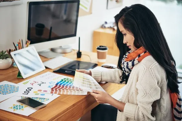 Creative professional designing marketing materials for graphic design services through nearshore collaboration.